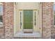 Charming home's front door with sidelights and a brick facade exudes a warm welcome to guests and visitors alike at 9037 Carnation Dr, Noblesville, IN 46060