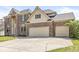 Close-up of a three-car garage with brickwork matching the two-story home at 9037 Carnation Dr, Noblesville, IN 46060