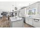 Bright kitchen with island, granite countertops, stainless appliances, and an open view of the living spaces at 9037 Carnation Dr, Noblesville, IN 46060