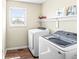 Functional laundry room with modern washer and dryer units, ample storage, and a convenient layout at 9037 Carnation Dr, Noblesville, IN 46060