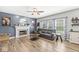 Cozy living room with a fireplace and hardwood floors and oversized sofa and windows showcasing a relaxing living space at 9037 Carnation Dr, Noblesville, IN 46060