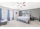 Spacious main bedroom with gray walls, a ceiling fan, and two large format landscape photograph prints at 9037 Carnation Dr, Noblesville, IN 46060