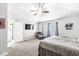 Bright and airy main bedroom with a ceiling fan, accent chair and ensuite bathroom at 9037 Carnation Dr, Noblesville, IN 46060
