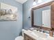 Elegant powder room with stone counters and framed mirror showcasing a beautiful area for guests at 9037 Carnation Dr, Noblesville, IN 46060