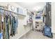 Spacious walk-in closet featuring built-in shelving, hanging rods, and carpet flooring at 9037 Carnation Dr, Noblesville, IN 46060