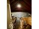 Unfinished attic space with exposed beams, subflooring, and insulation at 908 E 32Nd St, Anderson, IN 46016