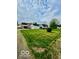 Backyard view of a home with a detached garage, set on a spacious lawn at 908 E 32Nd St, Anderson, IN 46016
