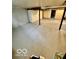 Unfinished basement with concrete floors, showing potential for customization and additional living space at 908 E 32Nd St, Anderson, IN 46016