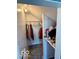 Walk-in closet featuring hanging clothes, storage and carpet floors at 908 E 32Nd St, Anderson, IN 46016