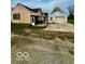 Exterior view of a home with a detached garage, offering ample parking and outdoor space at 908 E 32Nd St, Anderson, IN 46016