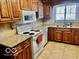 Well-equipped kitchen with solid countertops, appliances, and ample storage space at 908 E 32Nd St, Anderson, IN 46016