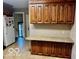 Traditional kitchen featuring wood cabinets, granite counters, and a white refrigerator at 908 E 32Nd St, Anderson, IN 46016