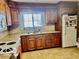 Functional kitchen with wooden cabinets, updated appliances, and plenty of countertop space at 908 E 32Nd St, Anderson, IN 46016