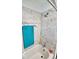 Close-up of a tub and shower featuring elegant white marble-patterned wall tiles at 908 E 32Nd St, Anderson, IN 46016