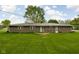 Backyard featuring lush green grass and the brick exterior of the home at 9303 Leroy Rd, Brownsburg, IN 46112