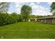 Expansive backyard featuring a lush green lawn and mature trees at 9303 Leroy Rd, Brownsburg, IN 46112