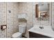 Bathroom featuring a vanity, toilet, wallpaper, and unique built-in features at 9303 Leroy Rd, Brownsburg, IN 46112