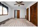 Carpeted bedroom with closets, ceiling fan, and natural light at 9303 Leroy Rd, Brownsburg, IN 46112