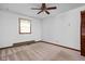 Bedroom with neutral carpet, one window, ceiling fan and side door at 9303 Leroy Rd, Brownsburg, IN 46112