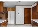 Bright kitchen featuring a white refrigerator, linoleum flooring, and patterned wallpaper at 9303 Leroy Rd, Brownsburg, IN 46112