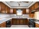 Kitchen featuring white countertops and dark wood cabinets at 9303 Leroy Rd, Brownsburg, IN 46112