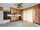 Open-concept kitchen and living area with wood paneling, ceiling fan, and natural light at 9303 Leroy Rd, Brownsburg, IN 46112