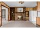 Living room featuring a brick fireplace, built-in shelves, and an open doorway to the dining area at 9303 Leroy Rd, Brownsburg, IN 46112