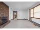 Spacious carpeted living room with a brick fireplace and large windows at 9303 Leroy Rd, Brownsburg, IN 46112