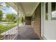 Covered front porch with brick facade and decorative metal railing at 9303 Leroy Rd, Brownsburg, IN 46112
