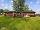 Spacious backyard featuring a cozy deck and a relaxing hot tub area, perfect for outdoor living at 961 N Dellasburg Rd, Columbus, IN 47203