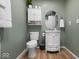 Well-lit bathroom with a white vanity, updated fixtures, and storage at 961 N Dellasburg Rd, Columbus, IN 47203