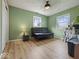 Bright bedroom with wood-look floors and neutral wall paint, creating a versatile space at 961 N Dellasburg Rd, Columbus, IN 47203