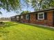Lovely single-story brick home with black shutters and a meticulously maintained front lawn at 961 N Dellasburg Rd, Columbus, IN 47203