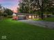 Charming brick home featuring a well-manicured lawn and a spacious two-car garage at 961 N Dellasburg Rd, Columbus, IN 47203