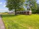Inviting single-story brick home with mature landscaping and a lush green front lawn at 961 N Dellasburg Rd, Columbus, IN 47203