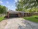 Well-maintained brick home with an attached two-car garage and neatly landscaped front yard at 961 N Dellasburg Rd, Columbus, IN 47203