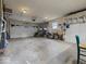 Spacious garage featuring two cars, lawn care equipment, and ample storage space at 961 N Dellasburg Rd, Columbus, IN 47203