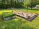 Well-kept garden featuring a planting bed and container, surrounded by a lush green lawn at 961 N Dellasburg Rd, Columbus, IN 47203