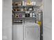 Functional laundry room features a washer, dryer, water heater, and ample storage shelves for convenience at 961 N Dellasburg Rd, Columbus, IN 47203