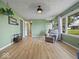 Inviting living room showcasing wood-look floors, neutral paint, and natural light from the window at 961 N Dellasburg Rd, Columbus, IN 47203