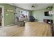 Bright living room with wood-look floors, comfortable seating, and a large window at 961 N Dellasburg Rd, Columbus, IN 47203