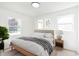 Cozy bedroom with natural light, a comfortable bed, and minimalist decor at 10132 E 33Rd St, Indianapolis, IN 46235