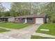 Single-story home with a brick and siding exterior, featuring a front yard and driveway at 10132 E 33Rd St, Indianapolis, IN 46235