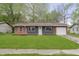 Charming single-story home with a brick and siding exterior and well-maintained lawn at 10132 E 33Rd St, Indianapolis, IN 46235