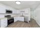 Modern kitchen with white cabinetry, stainless steel appliances, and sleek countertops at 10132 E 33Rd St, Indianapolis, IN 46235
