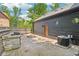 Entertainer's backyard featuring a fire pit, outdoor grill, and a fully fenced yard at 10455 Courageous Dr, Indianapolis, IN 46236