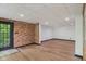 This finished basement area features exposed brick and a door to the exterior at 10455 Courageous Dr, Indianapolis, IN 46236