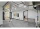 Unfinished basement area with a rubber floor and doorways to other areas of the basement at 10455 Courageous Dr, Indianapolis, IN 46236