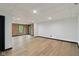 This finished basement area features exposed brick, recessed lighting and a black door at 10455 Courageous Dr, Indianapolis, IN 46236