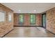 The basement features exposed brick walls, two windows and a black door leading to the backyard at 10455 Courageous Dr, Indianapolis, IN 46236